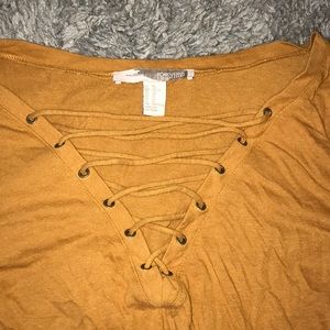 Burnt orange laced up long sleeve shirt.